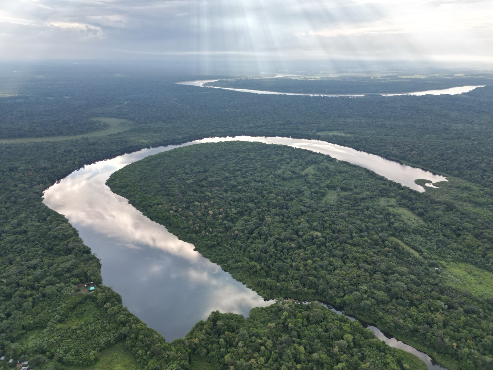 Aerial view of a horseshoe river bend in the Colombian Amazon at dawn